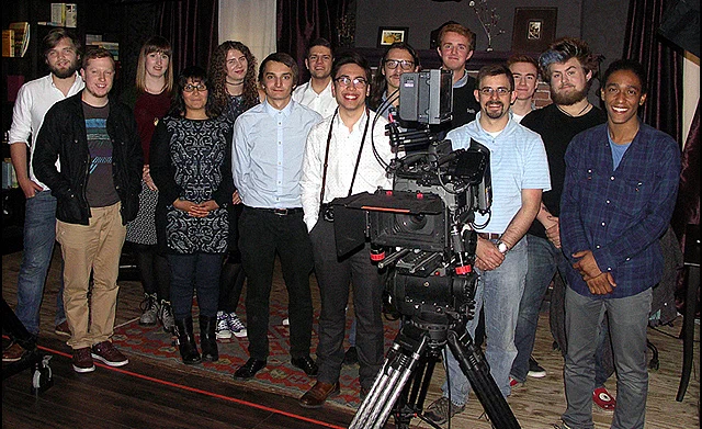 young media professionals around a digital motion picture camera