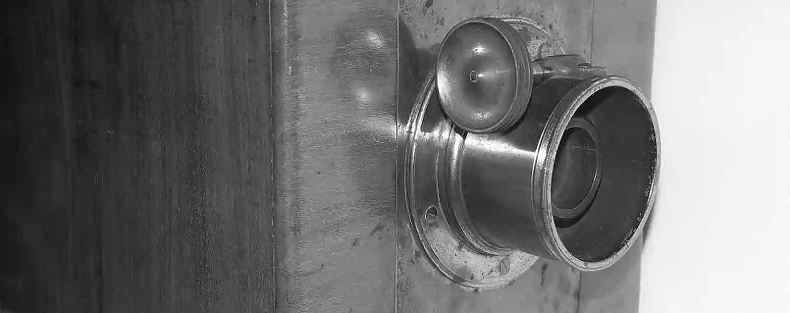 brass lens fitted onto front of wooden victorian photographic camera