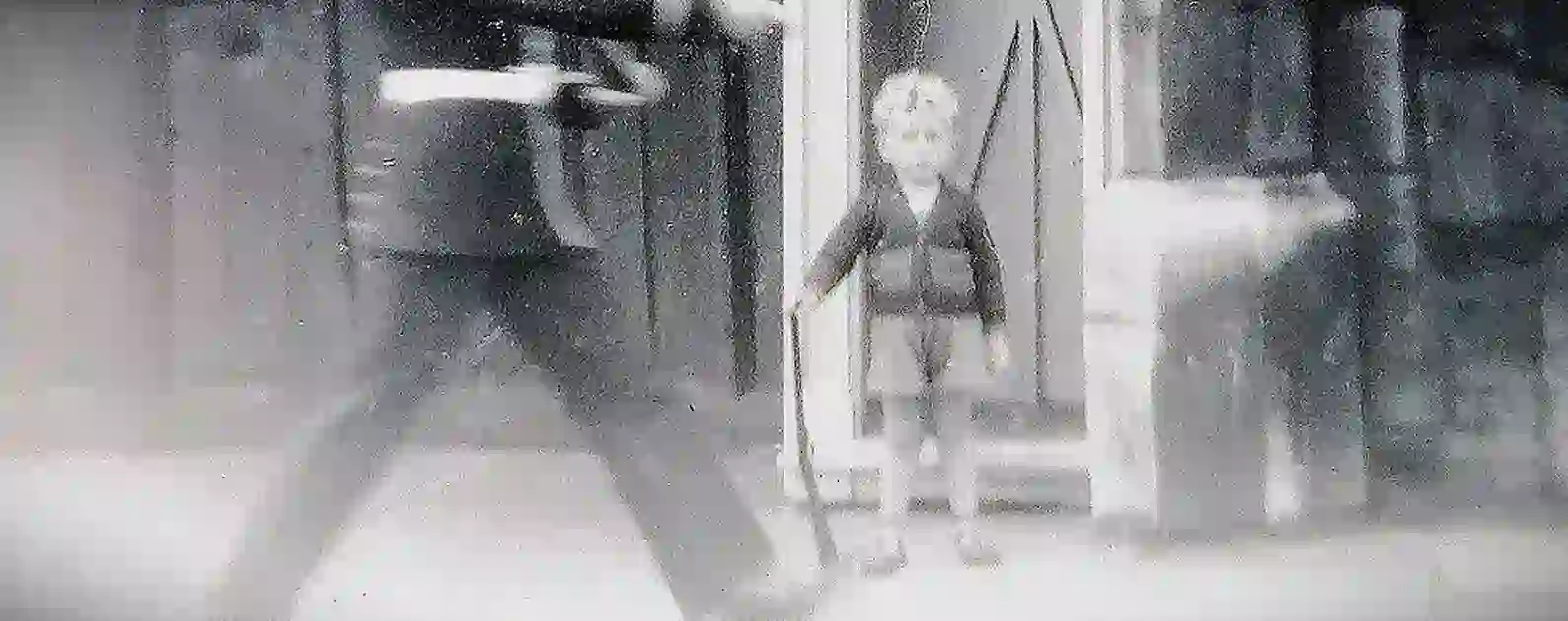 young boy posing in a soldiers sentry box