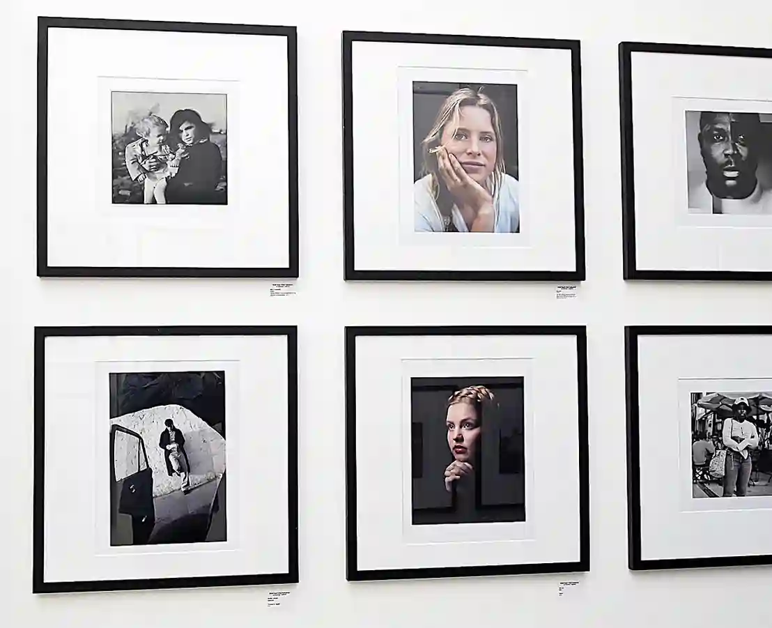 black framed photographic prints on a gallery wall