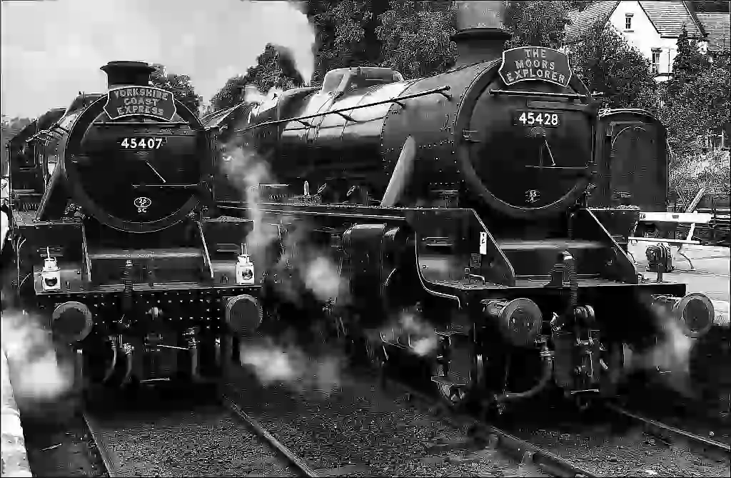 two steam locomotives in a station