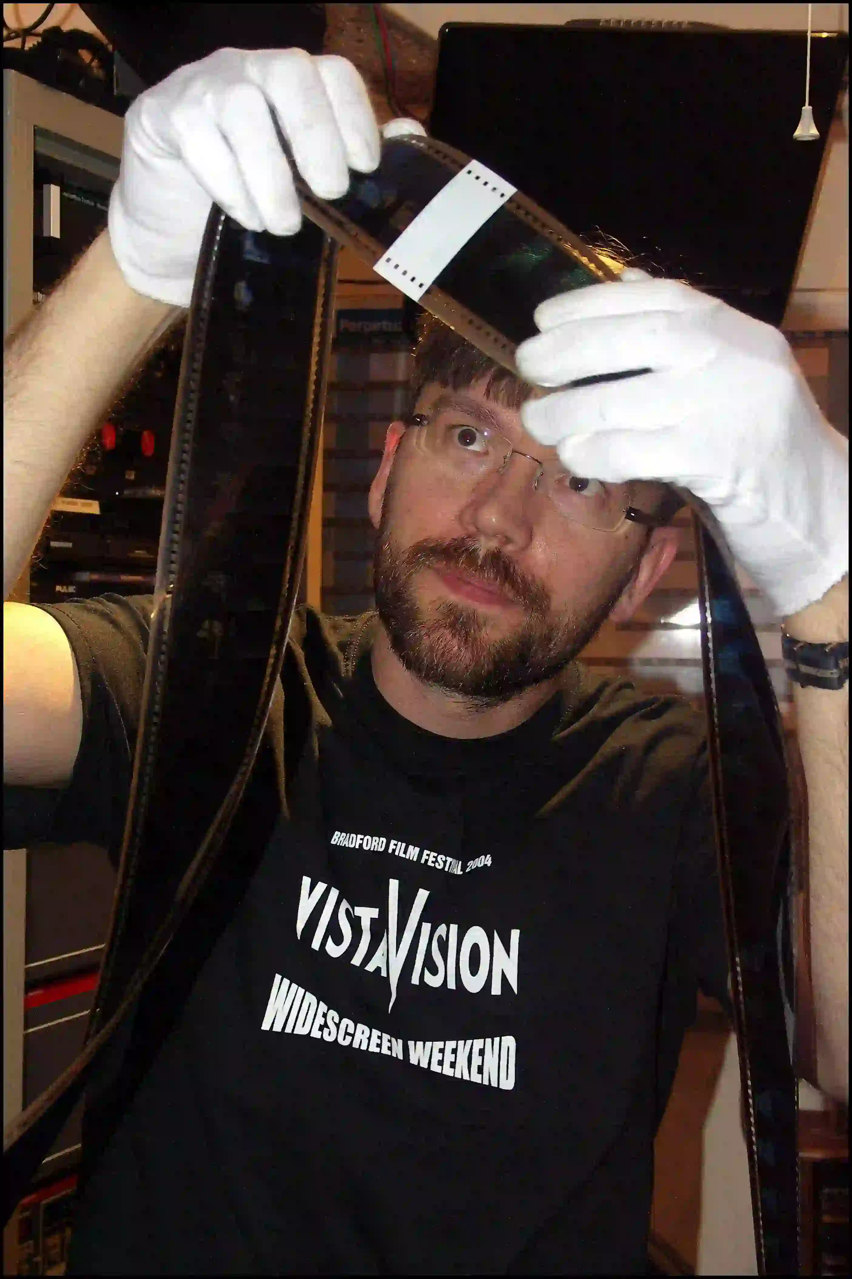 cinema projectionist handling 70mm film