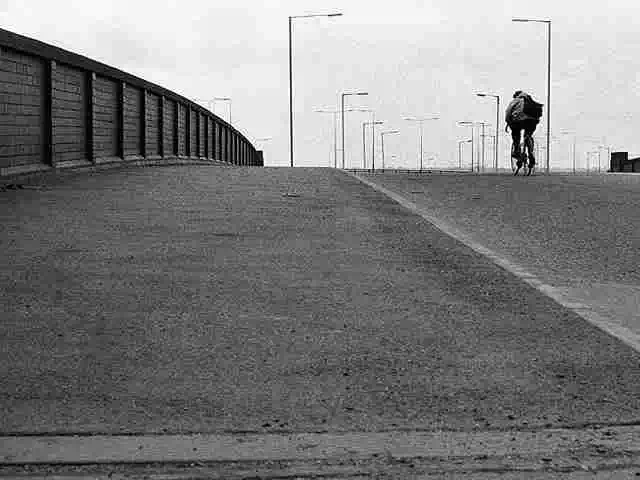 cyclist crossing an empty teesside bridge
