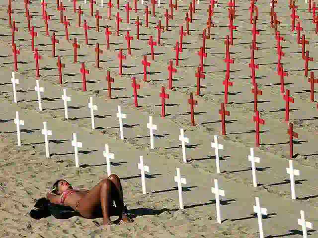 woman on santa monica beach with rows of crosses