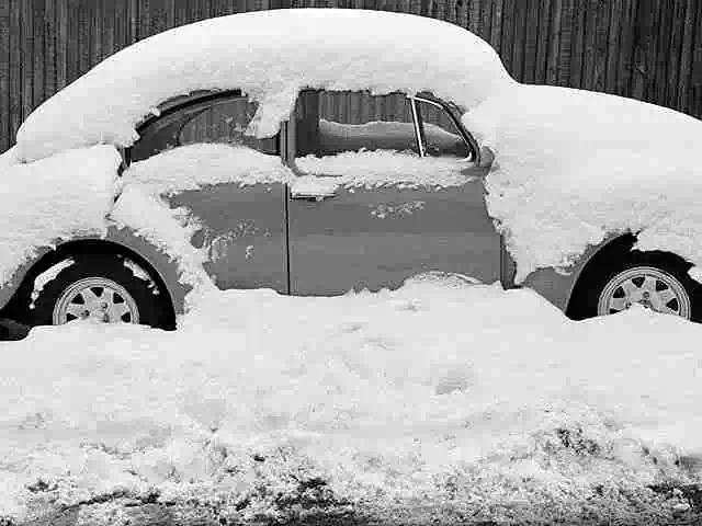 volkswagen car covered in snow